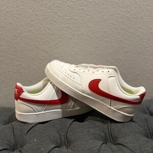 White Nikes with red swoosh. Laces needed. Womens size 8.5.